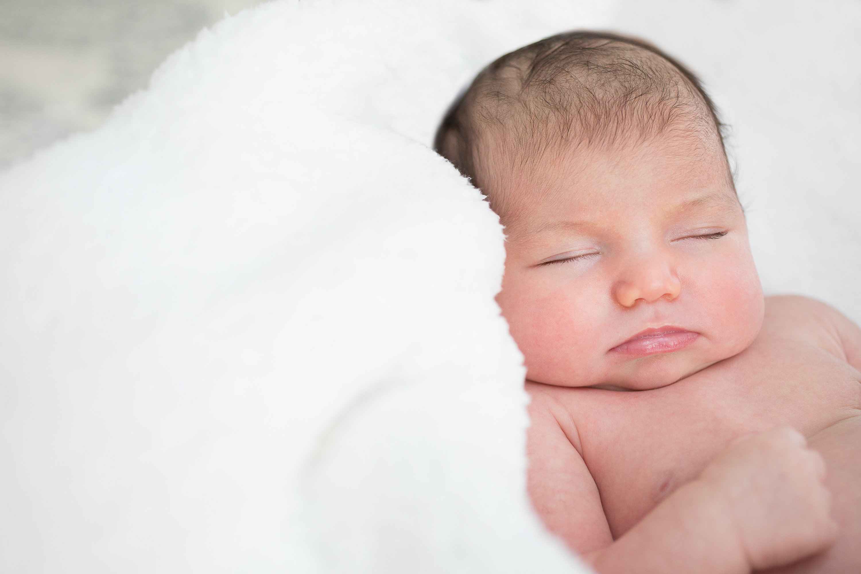 newborn-girl-in-white-blanket