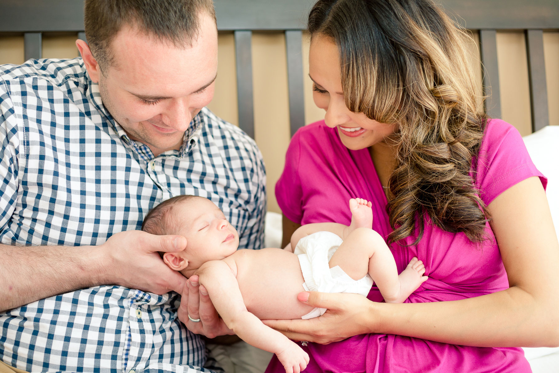 parents-hold-newborn-girl-in-their-hands